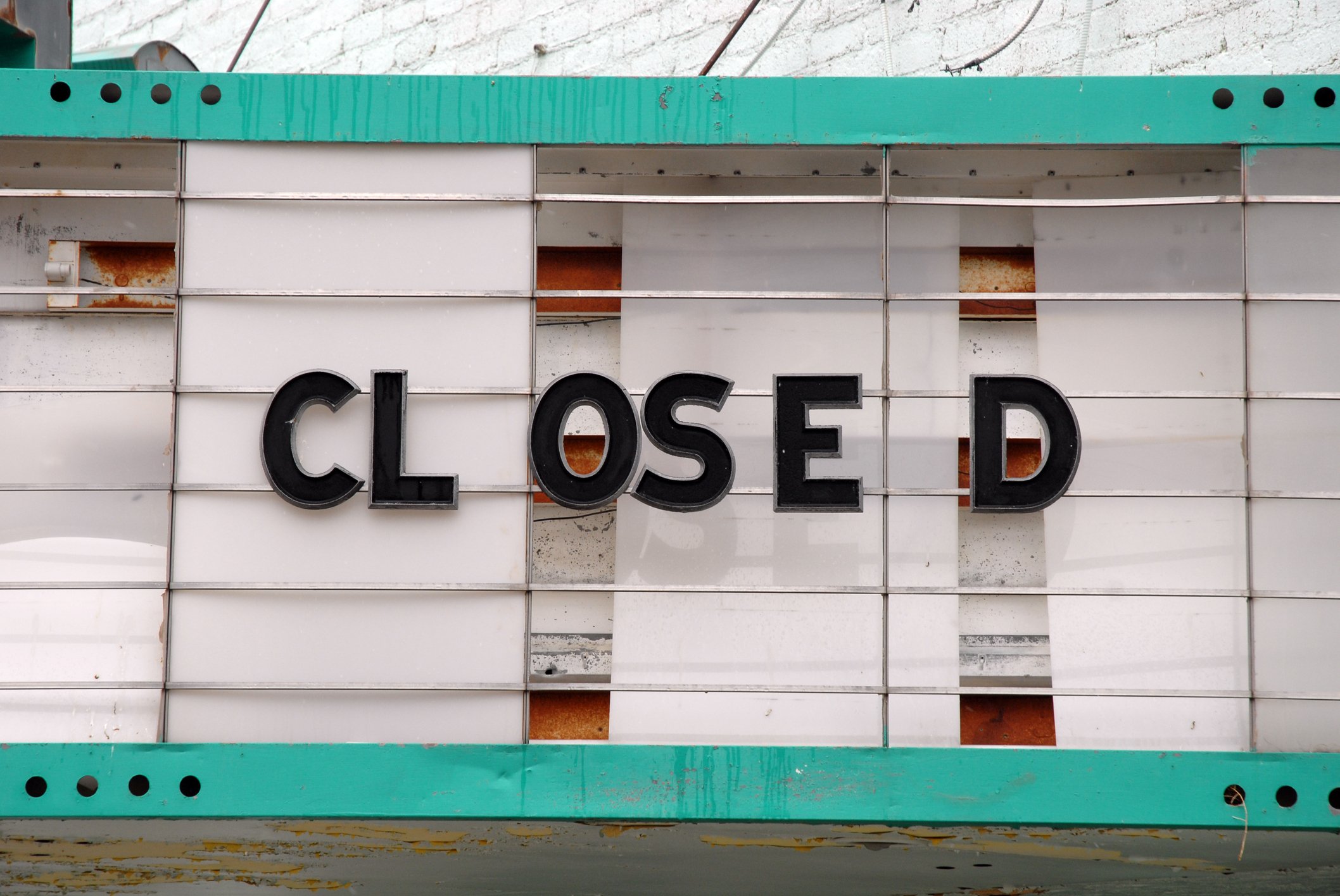 Letters spell CLOSED on a movie theater marquee