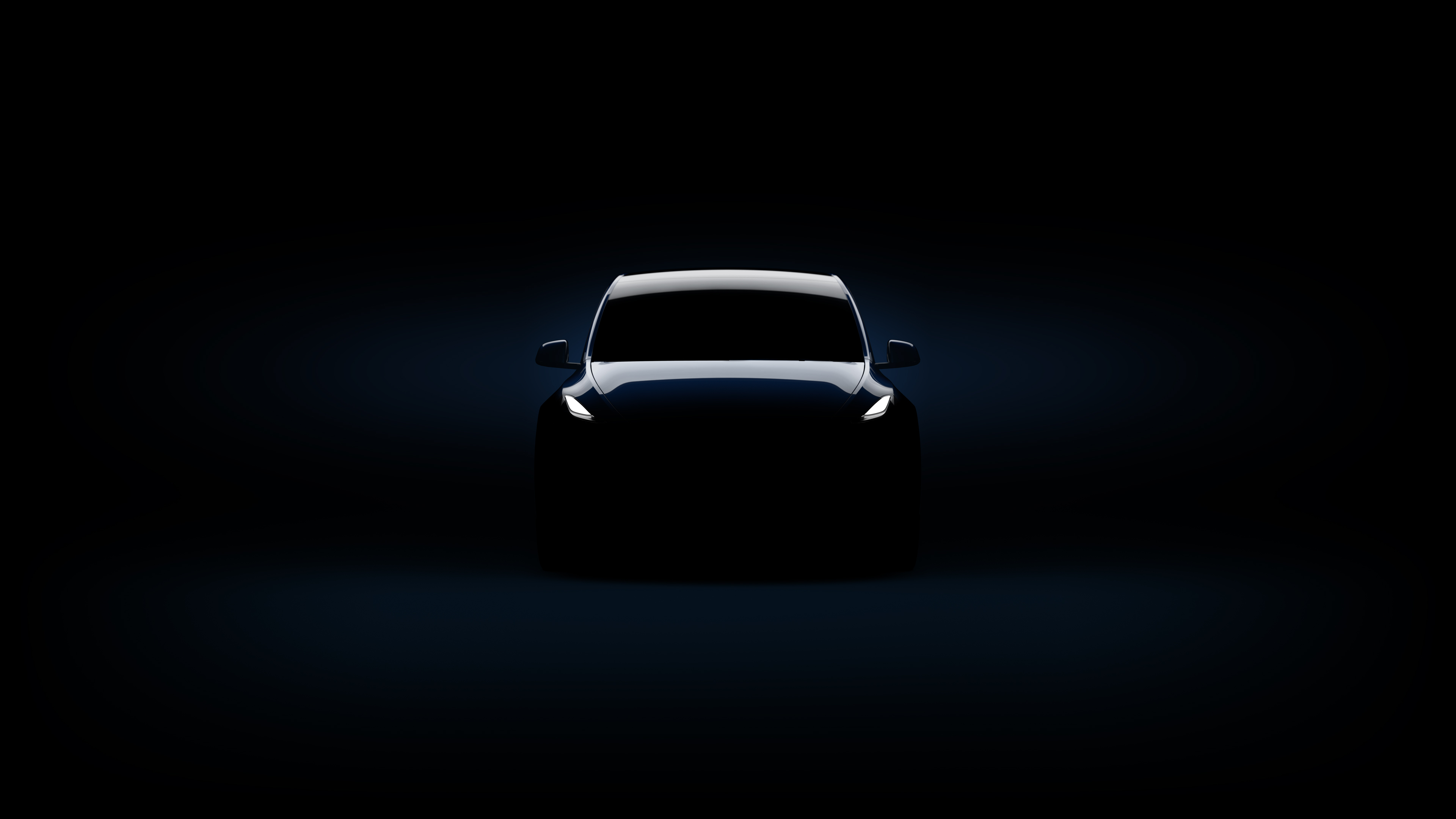 A Tesla Model Y, in a dark room.