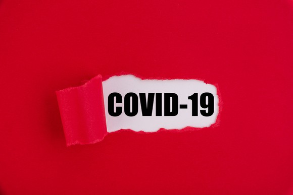 "COVID-19" written on red background.