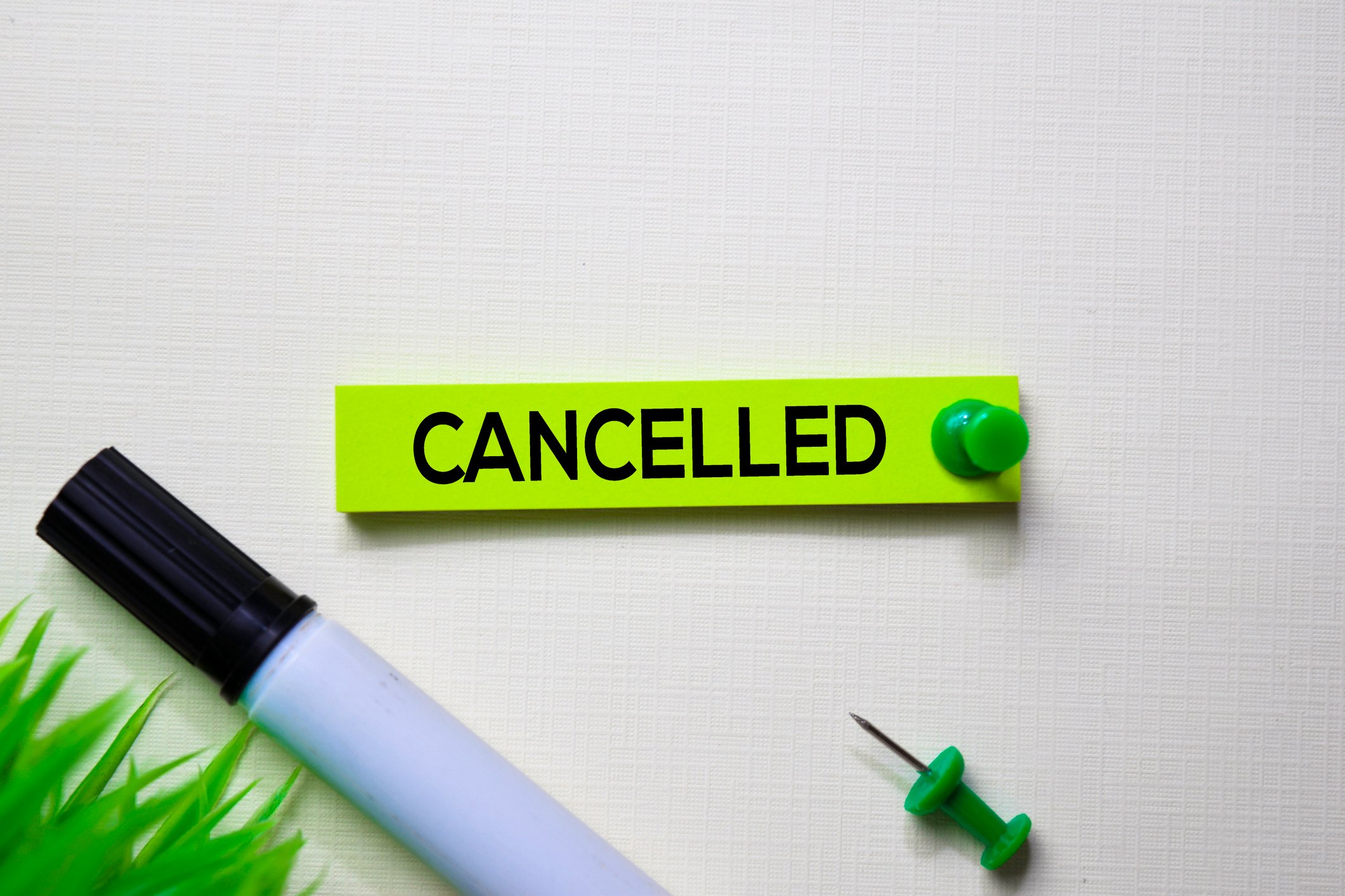 A sticky note with cancelled text.