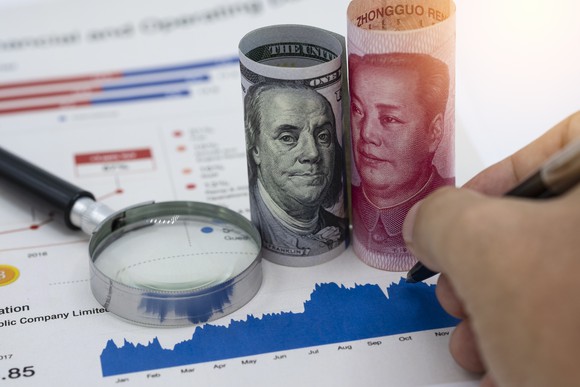U.S. and Chinese currency shown as well as an investment graph.