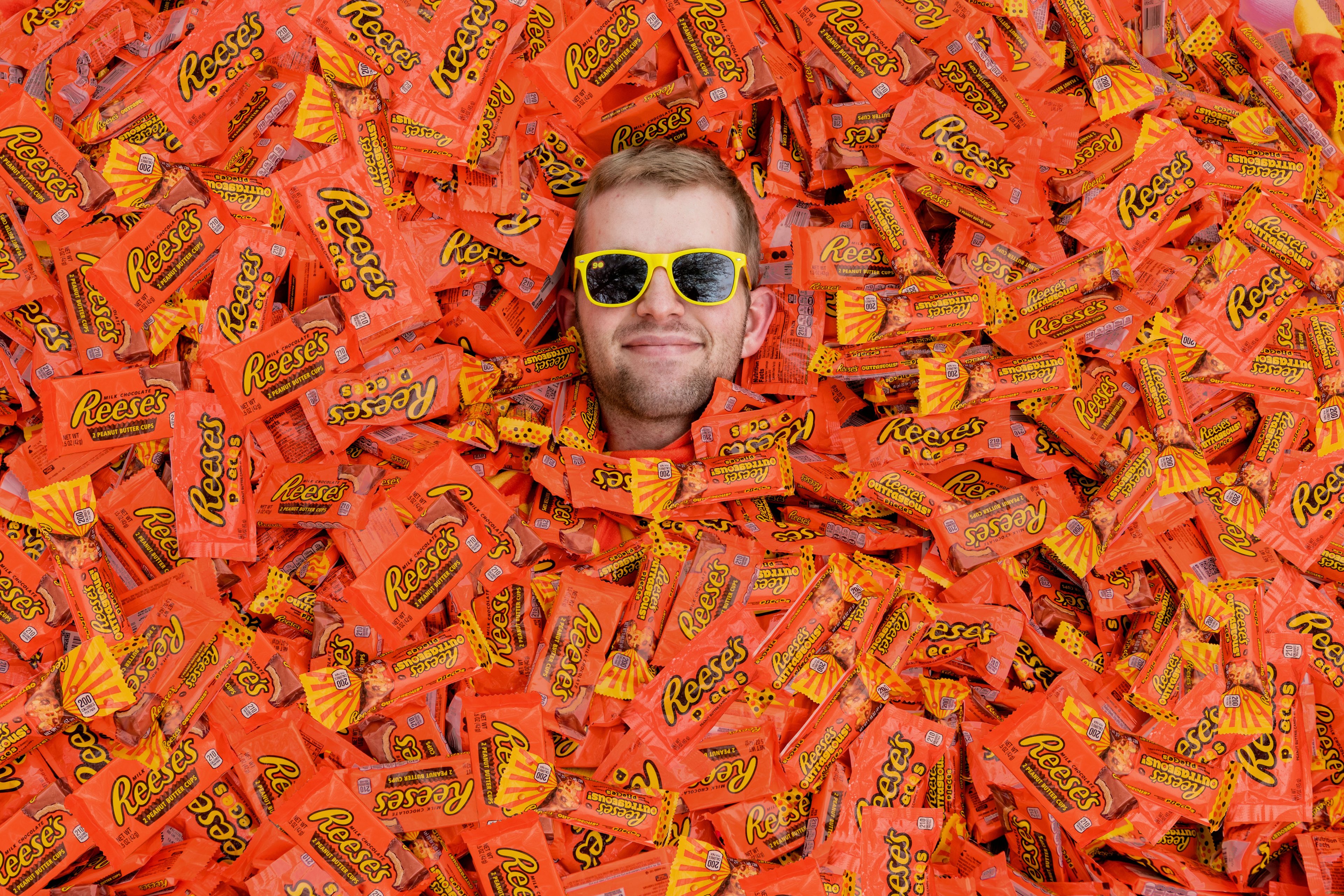 a Reese's fan is surrounded by packages of Reese's Cups