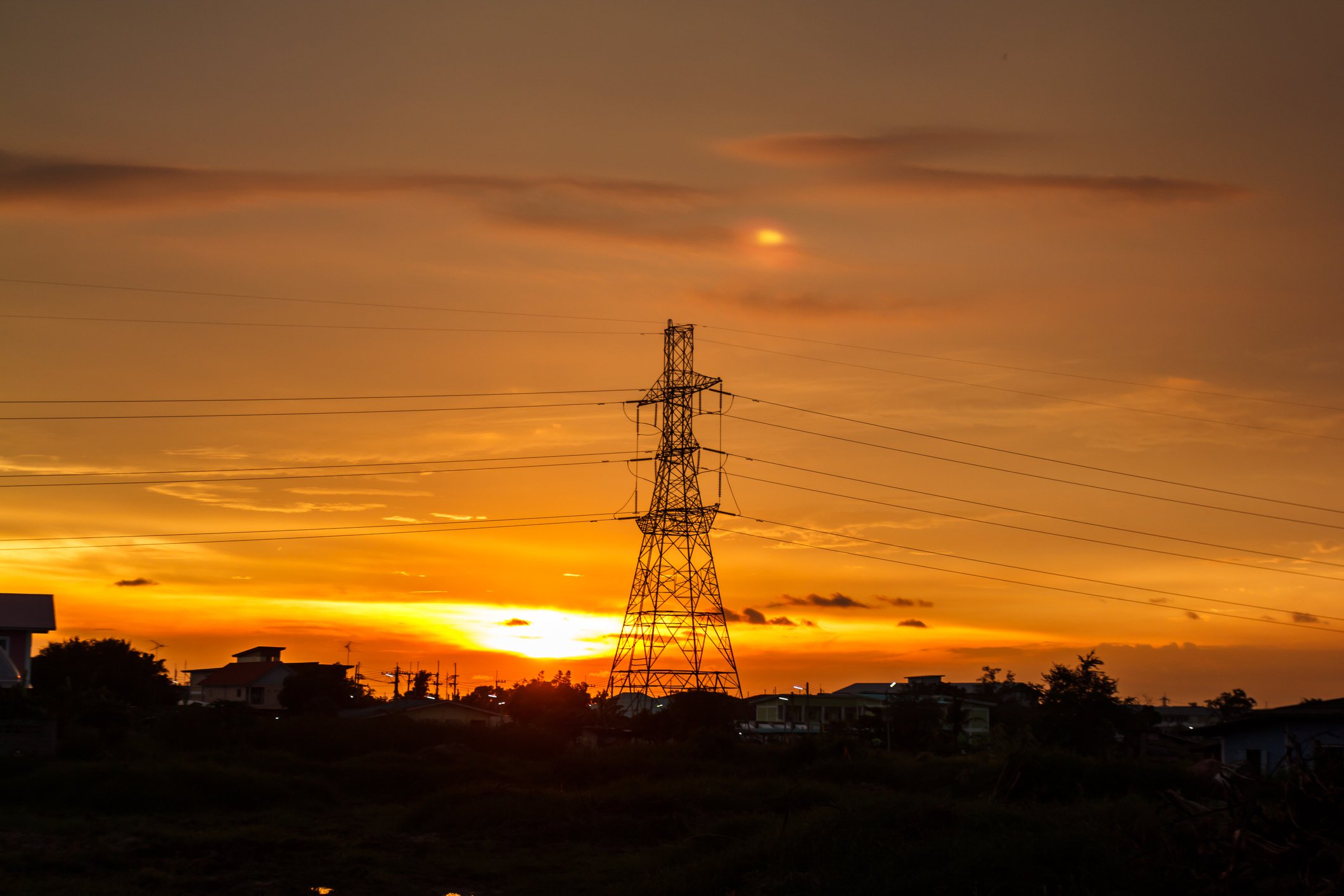 Utility power transmission poles at sunset.