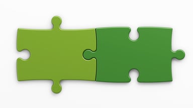 Two green jigsaw puzzle pieces