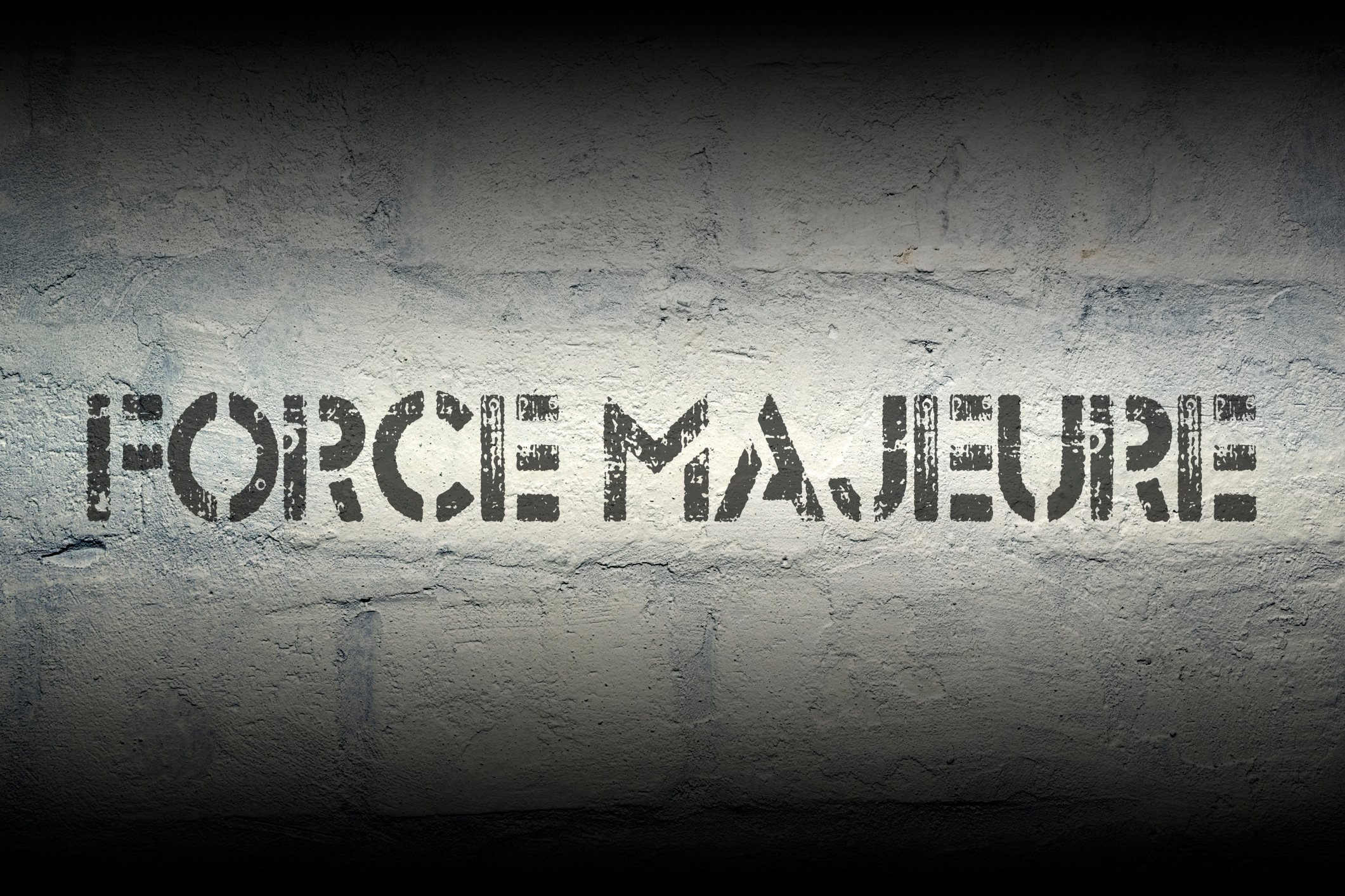 Words Force Majeure stenciled on a wall