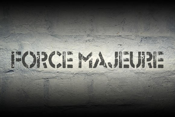 Words Force Majeure stenciled on a wall
