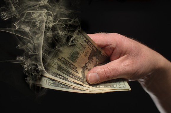 $20 bills being burned.