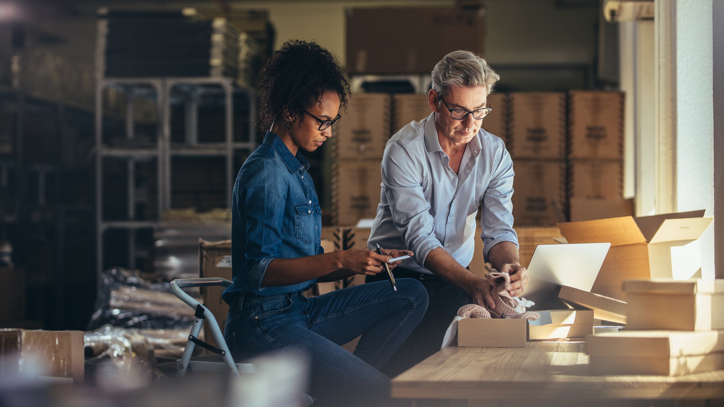 A man and a women look over documents in their small business