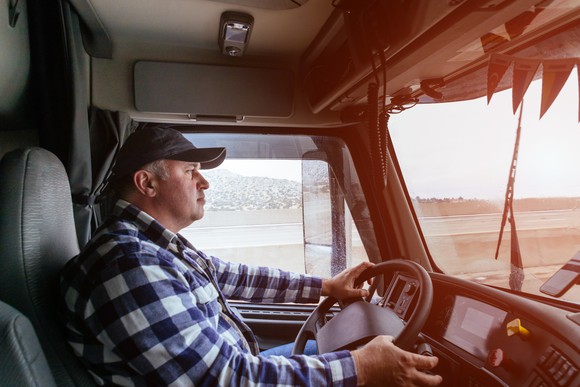 Truck driver in the cab of a rig
