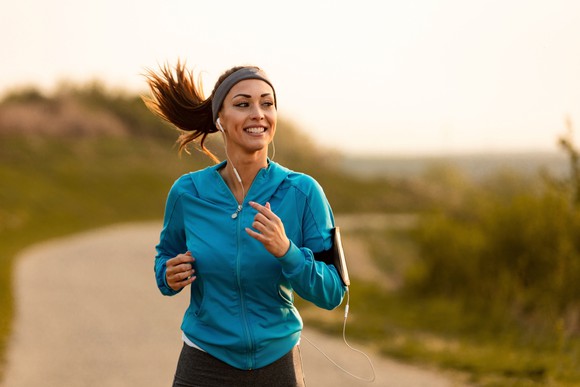 A woman running on an empty trail.