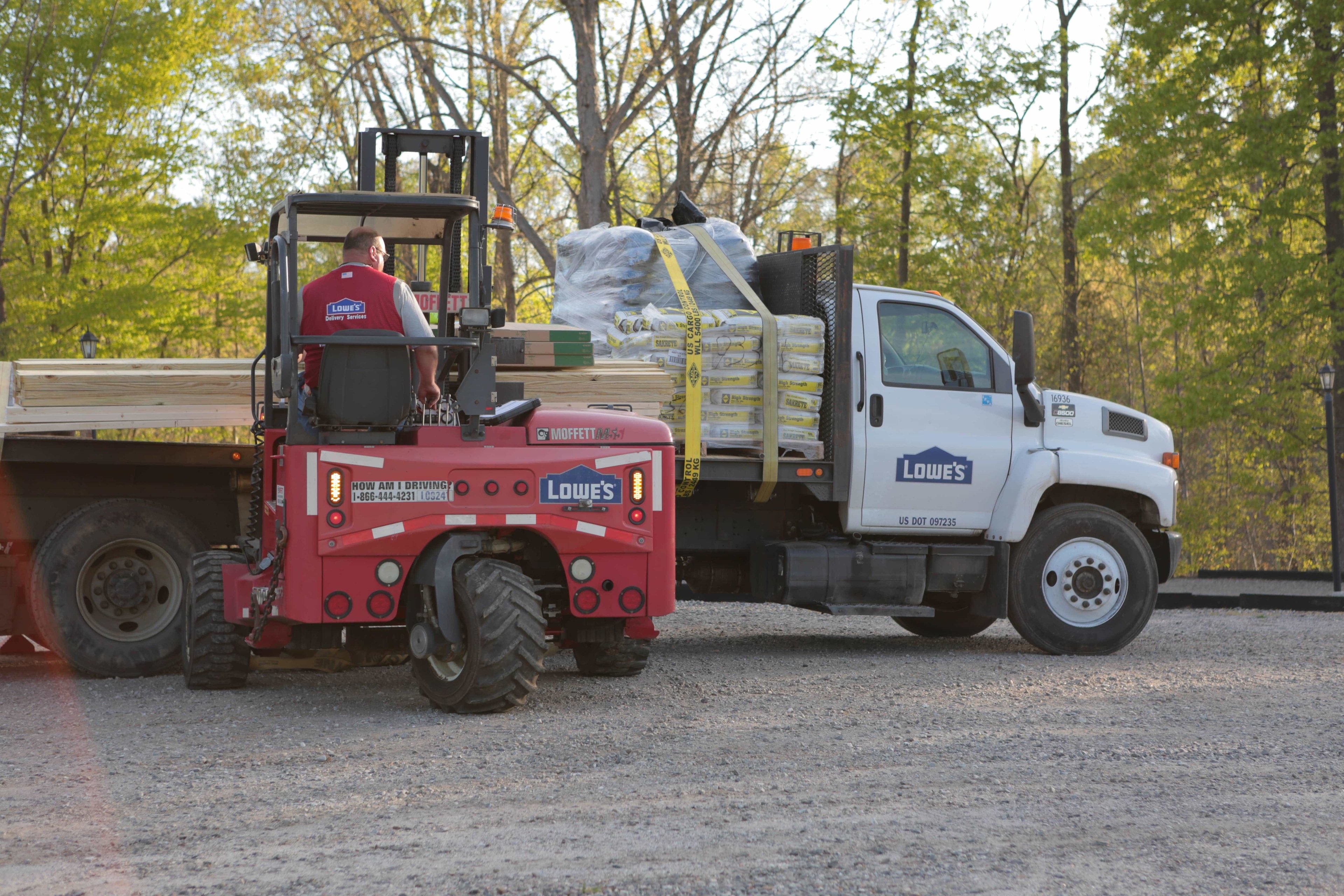 A Lowe's truck and forklift.