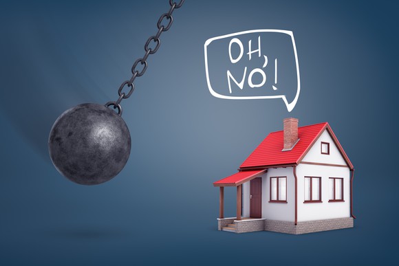 A house says, "Oh, no!" as a wrecking ball swings towards it.