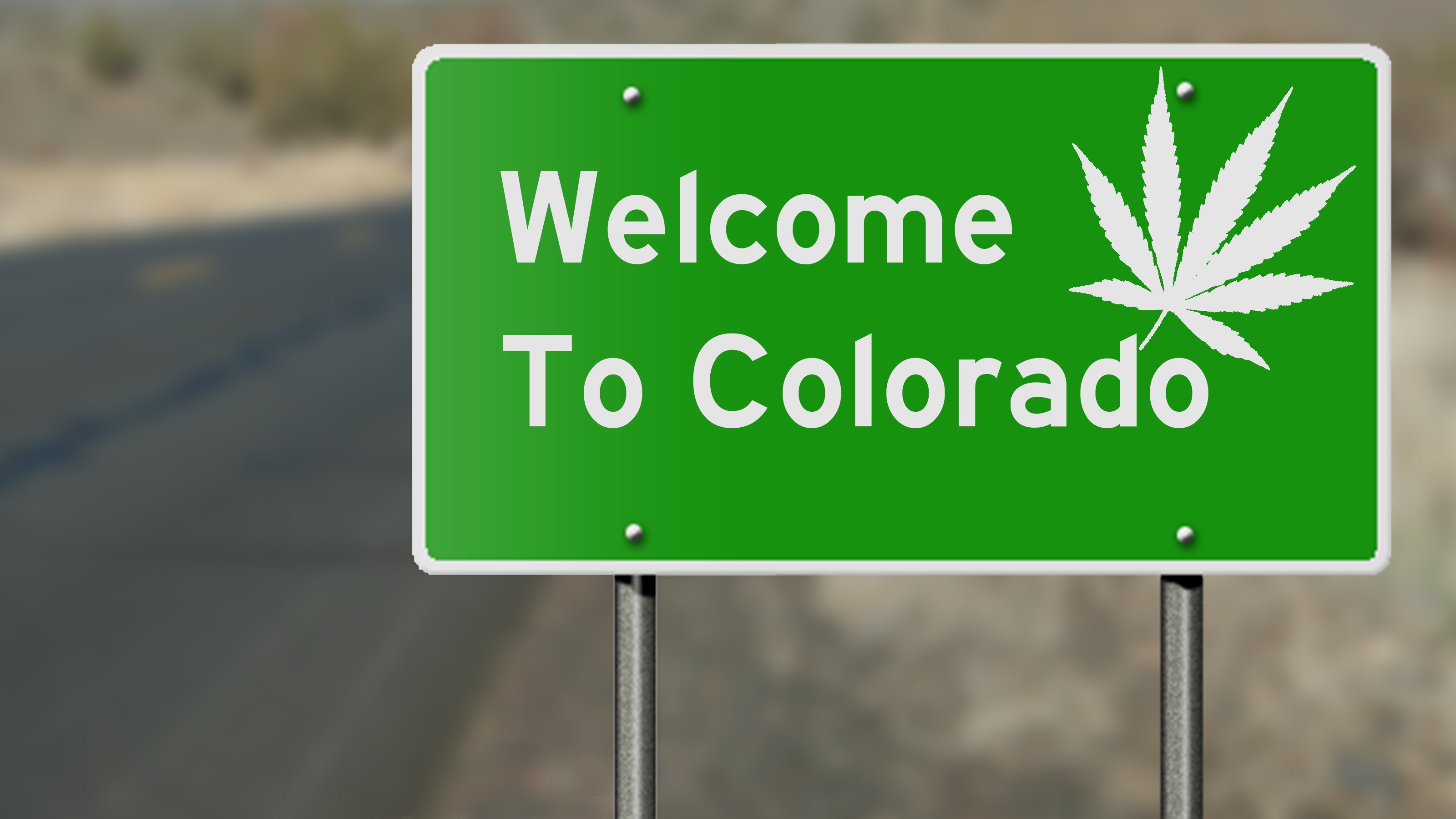 Welcome to Colorado road sign with marijuana leaf.