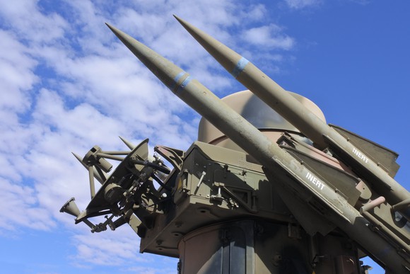 Missile and radar system against blue sky