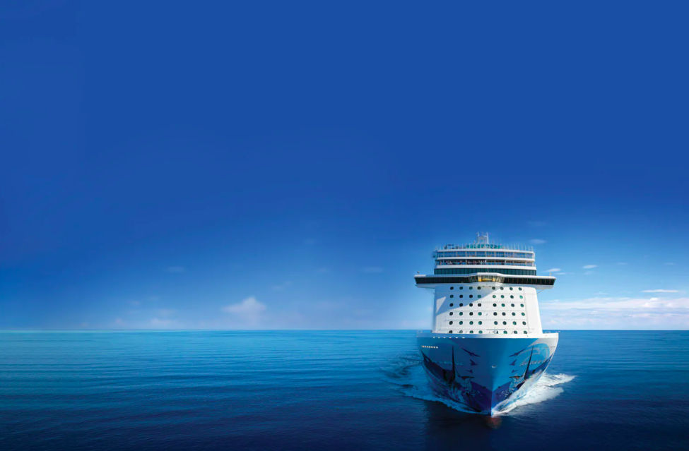 Rendering of a Norwegian Cruise Line ship coasting on a blue sea against a blue sky.