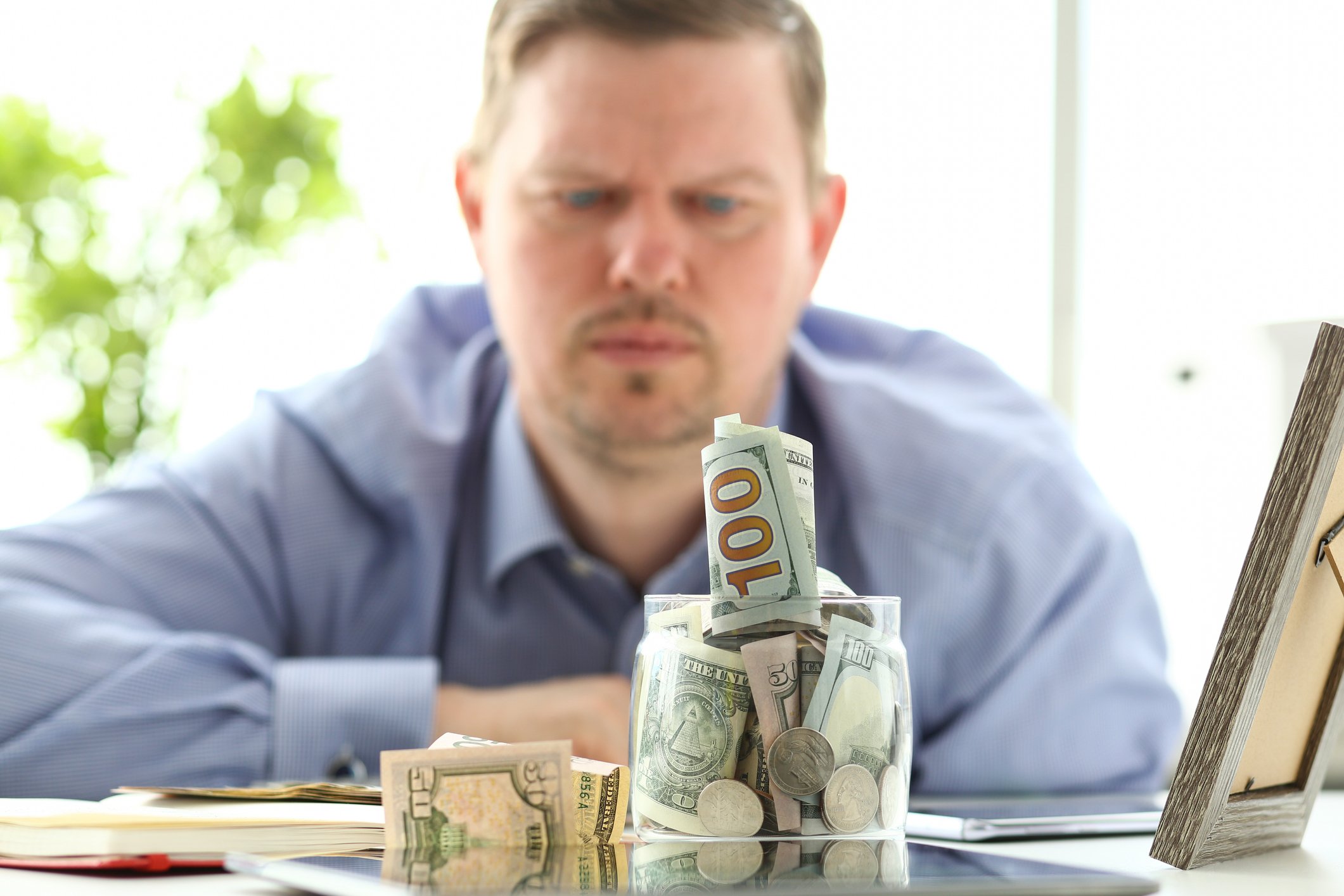 Man staring at his cash emergency fund