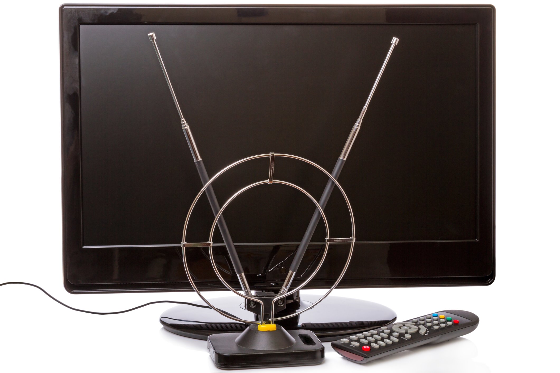 Rabbit ear TV antenna in front of a modern flat screen television