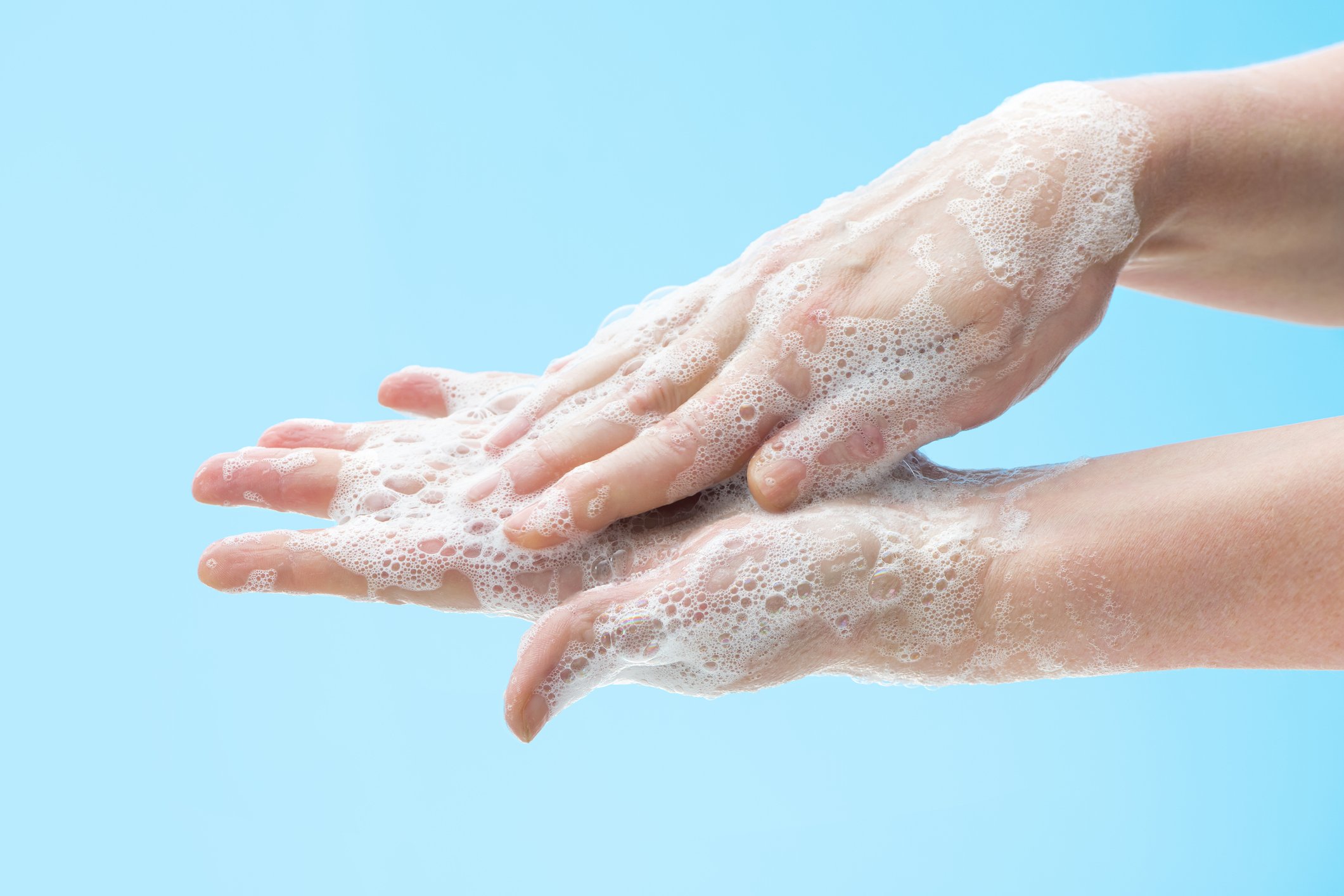 A woman washing her hands.