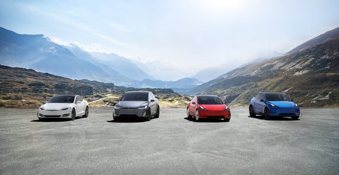 Four Tesla cars parked side by side.