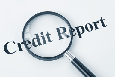 Words Credit Report under a magnifying glass