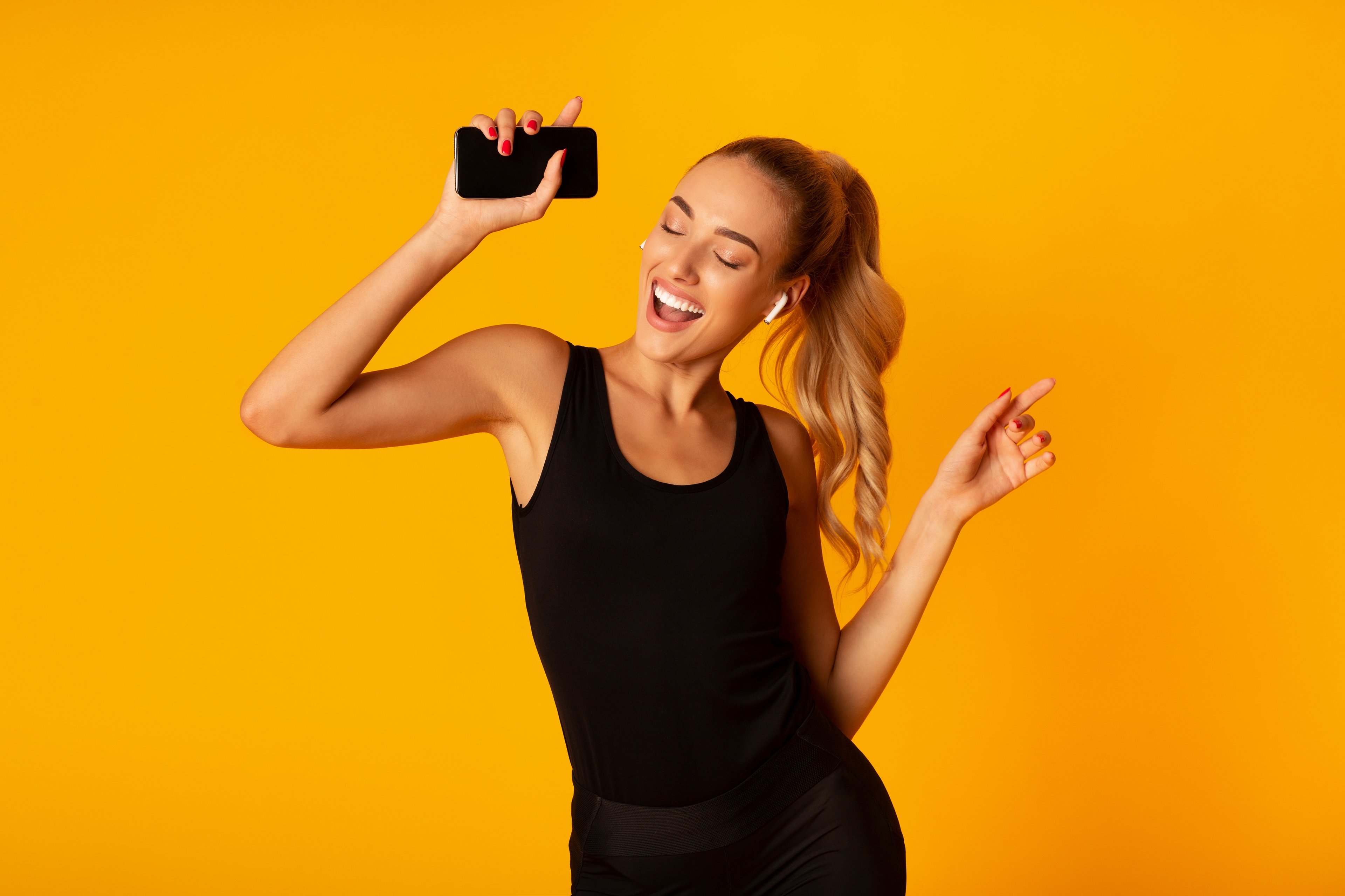 Woman dancing with smartphone. 