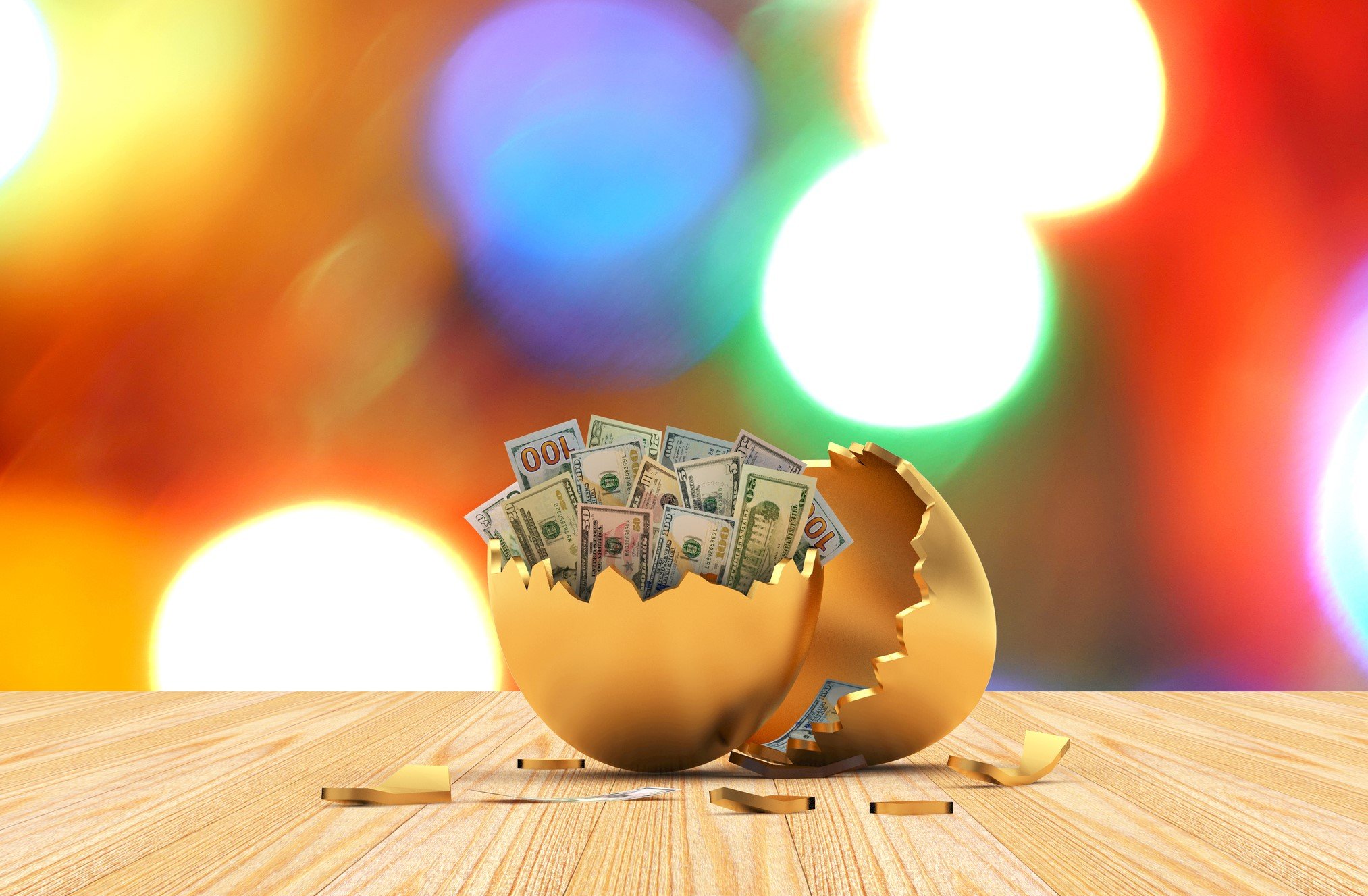 A cracked egg with $100 dollar bills inside.