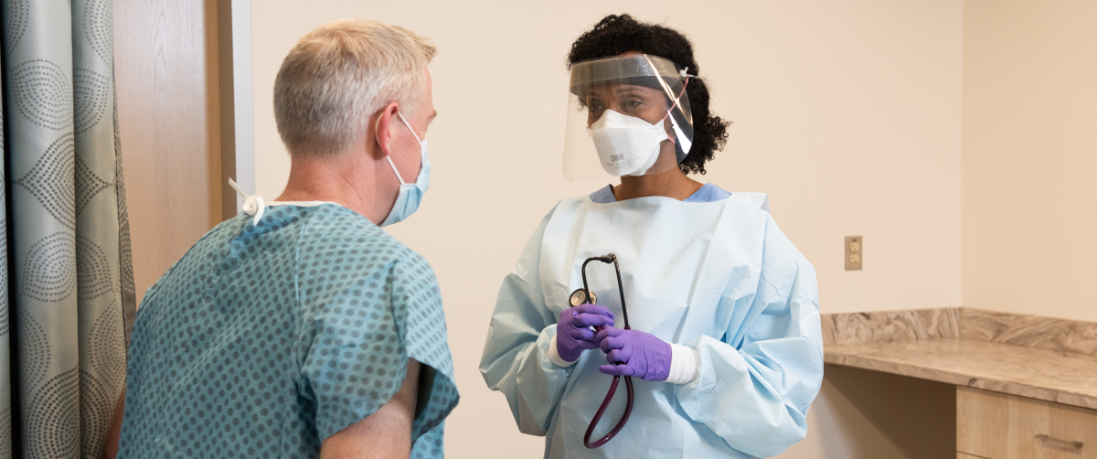 A doctor wearing a mask and face shield