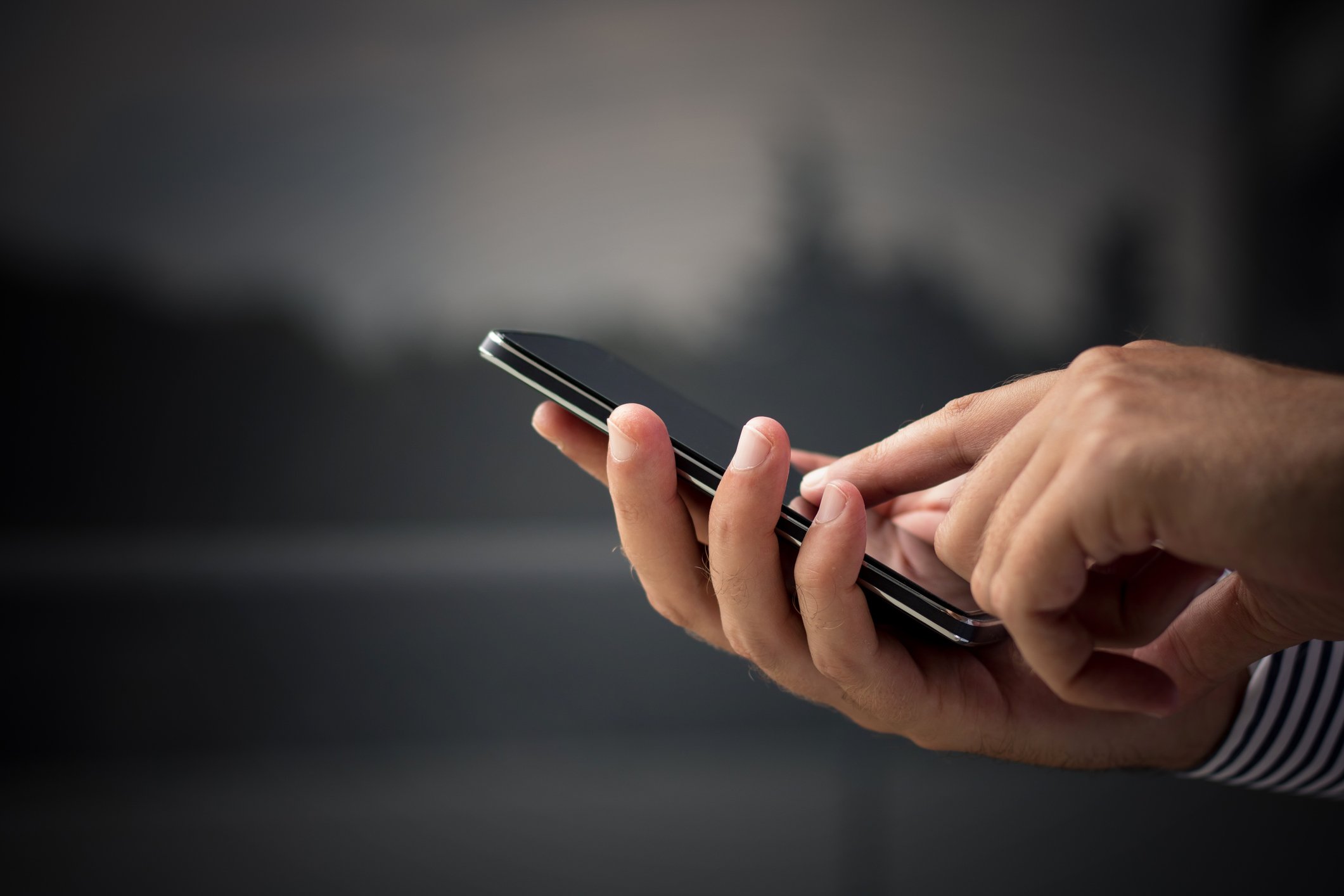 Hands using a mobile phone