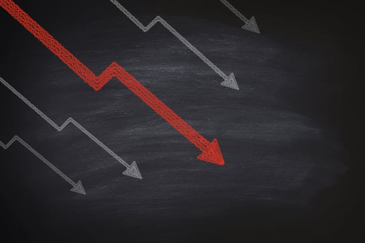 Declining arrows on a chalkboard.
