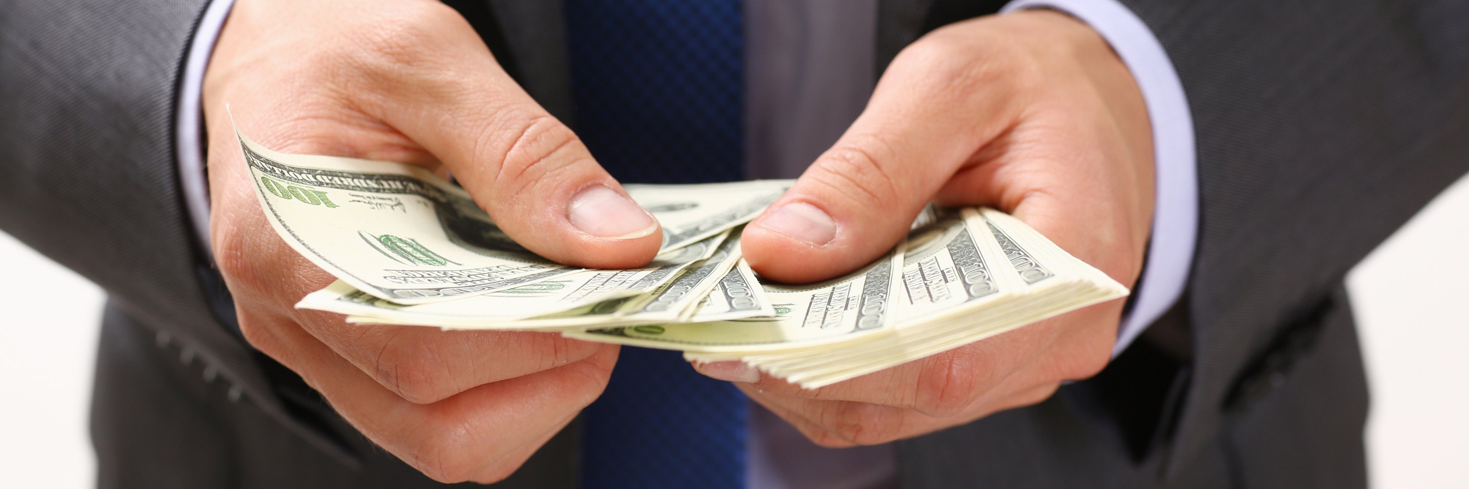 Banker counting out cash to loan