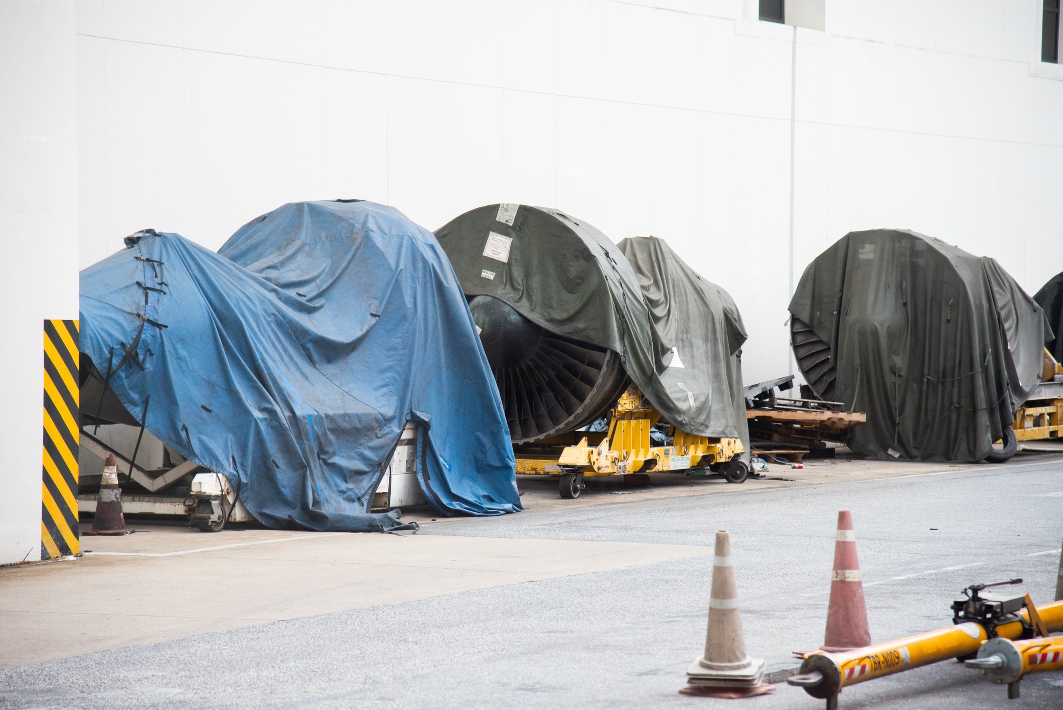 Covered aircraft engines being stored