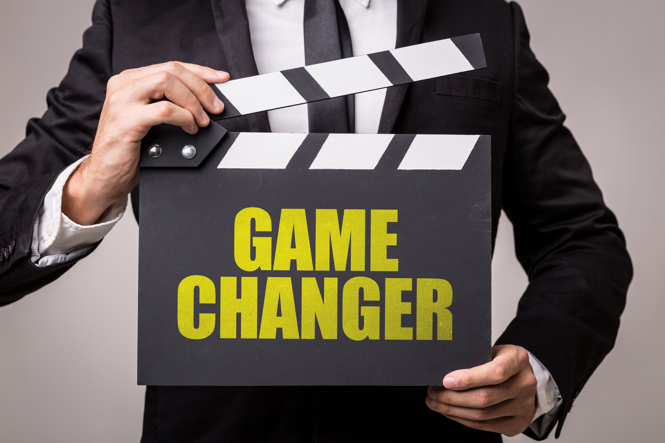 Man holding a clapperboard with Game Changer printed on it
