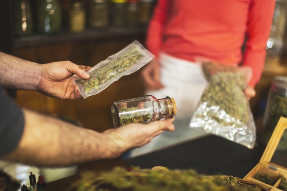 A person buys cannabis at a dispensary