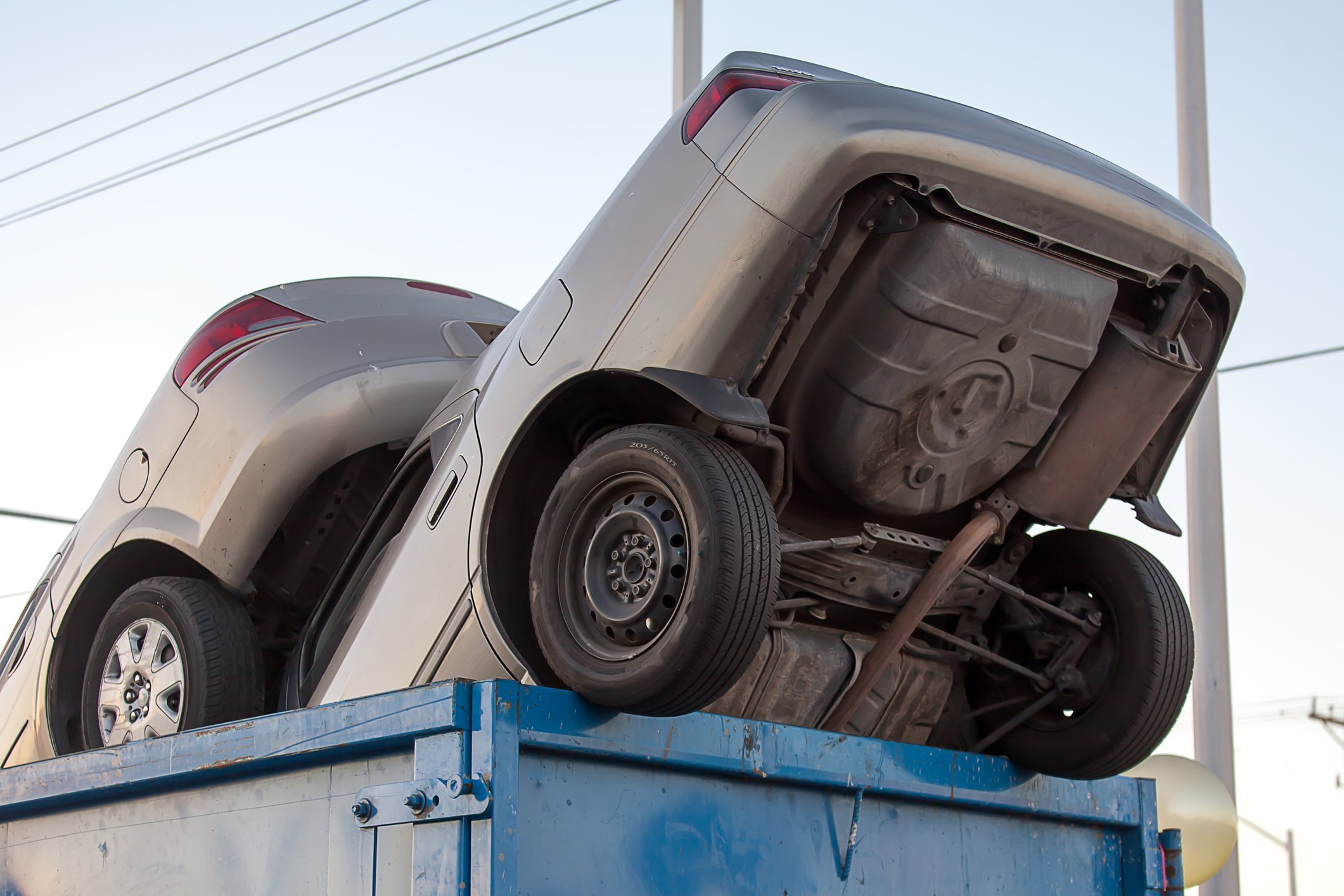 Clunker cars in a dumpster.