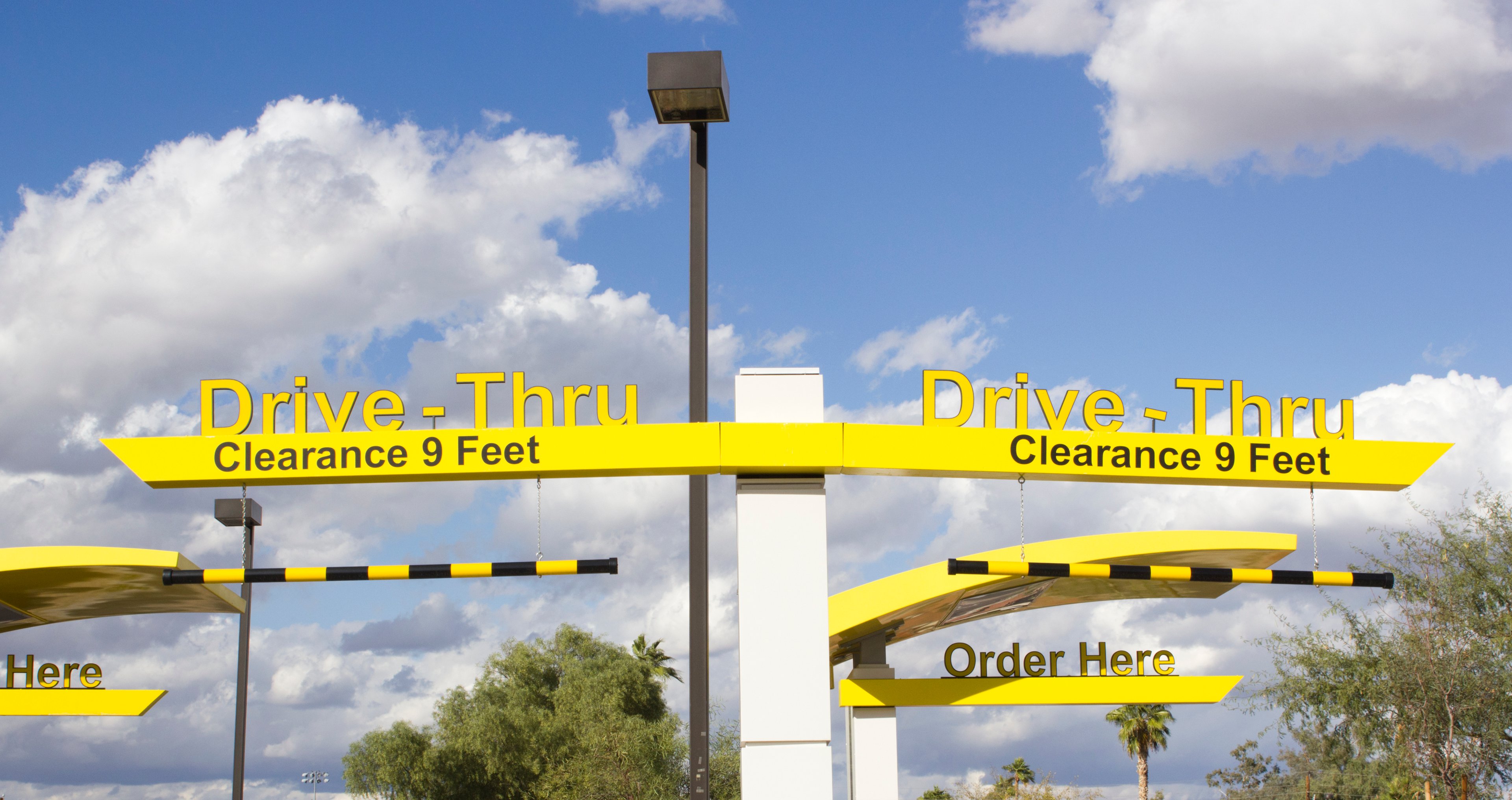 Yellow signage indicating restaurant drive-thru lanes.