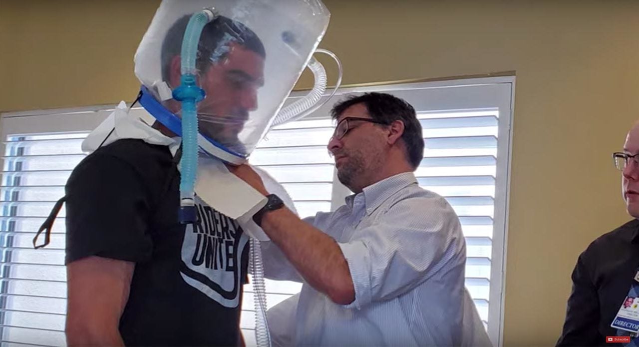 Doctor testing an oxygen hood prototype