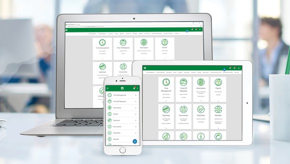 The Paycom application displayed on a laptop, a tablet, and a smartphone