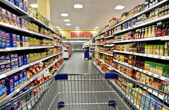 Cart in a grocery store aisle.