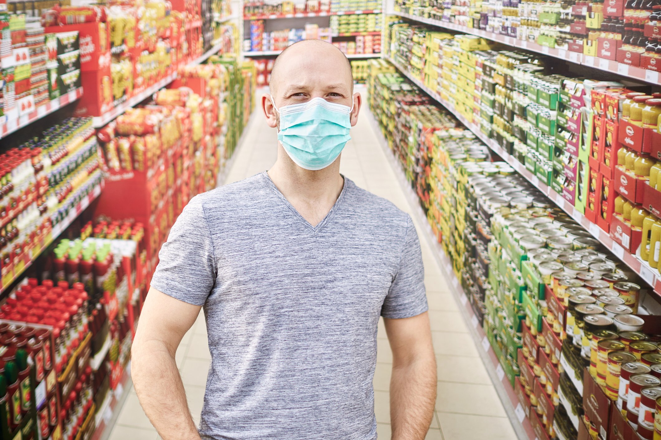 A man in a grocery store wearing a protective face mask.