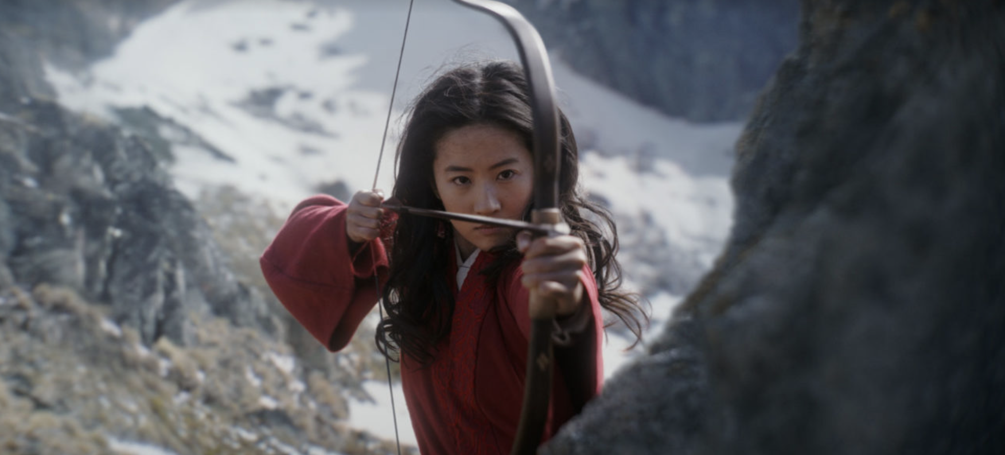 An image from the live action version of the Disney movie Mulan shows Mulan about the fire an arrow from a bow