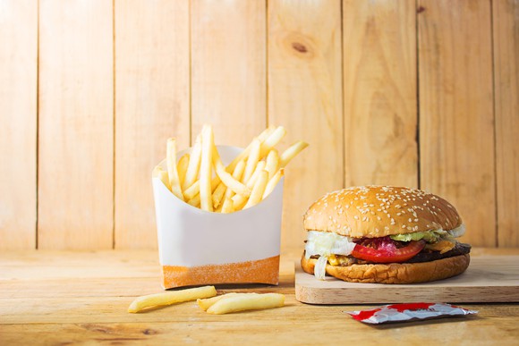 A hamburger and french fries on a table.