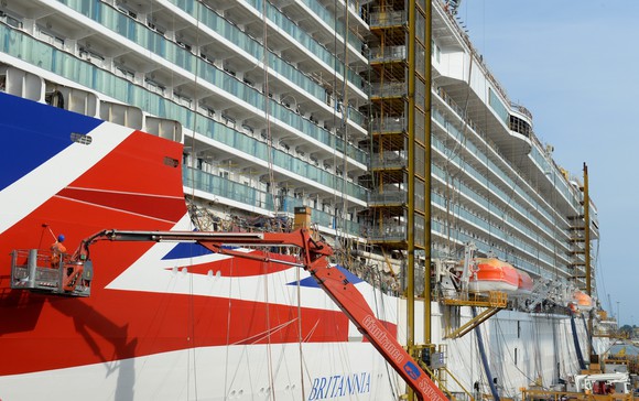 A view of workers refreshing the paint on a Carnival ship.