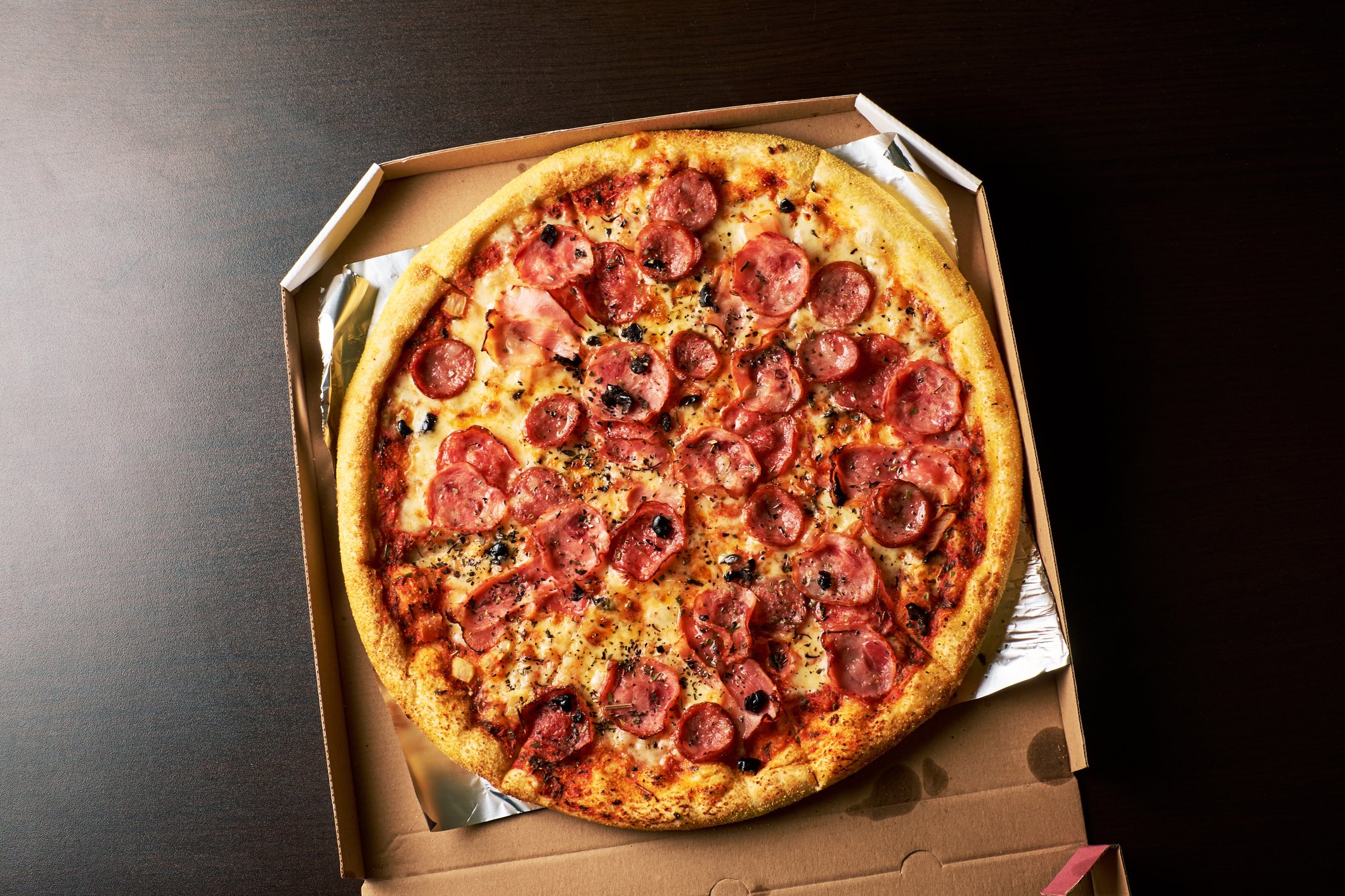 A pepperoni pizza with extra cheese in a box.