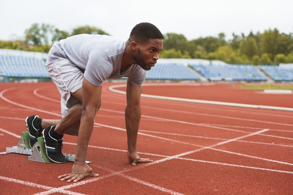 Man getting ready on a track.