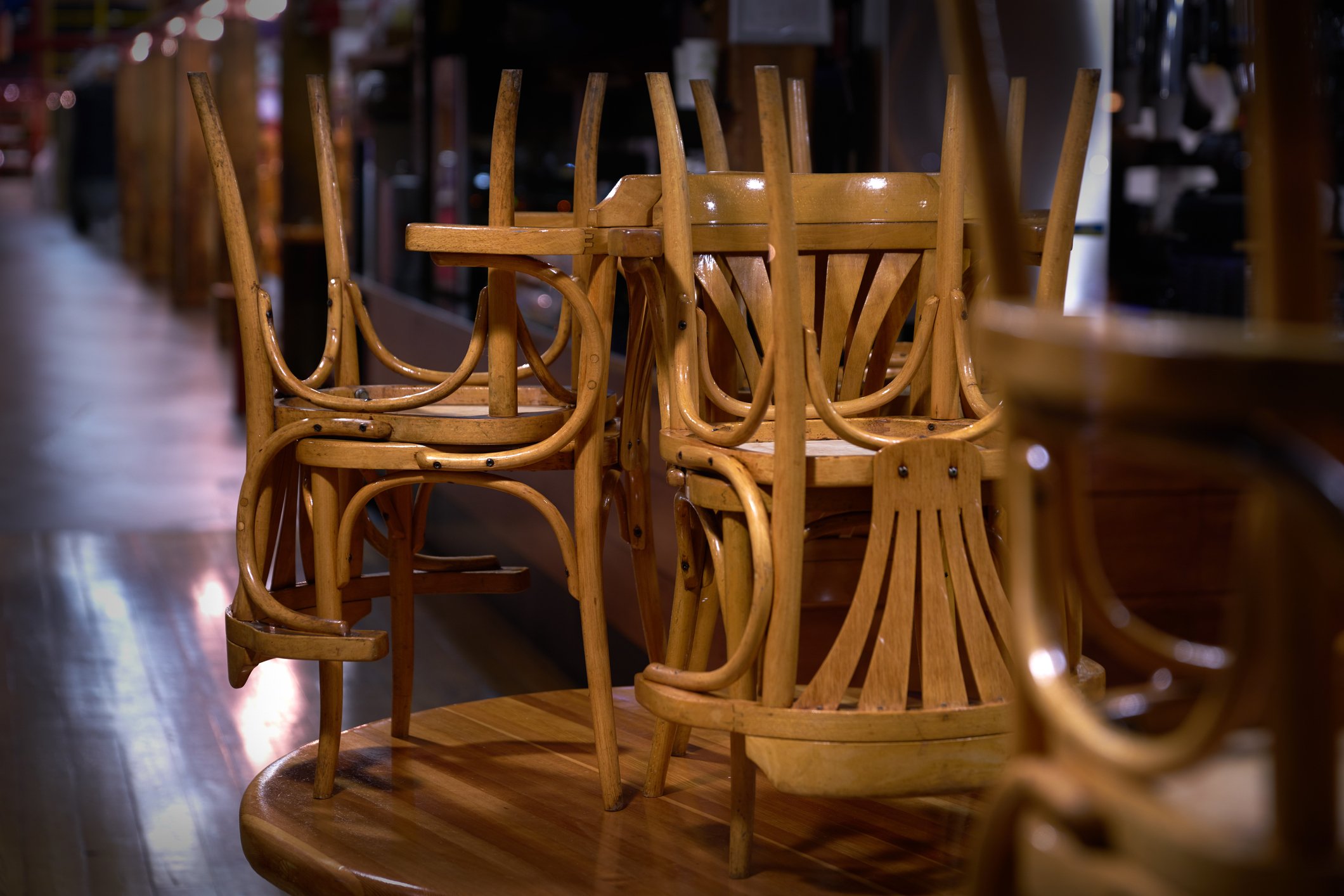 An empty restaurant with chairs stacked.