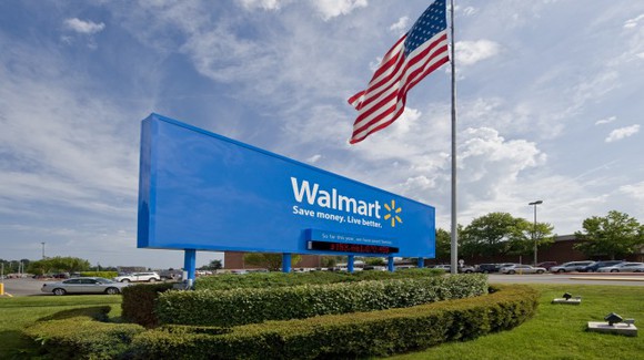 Walmart sign next to an American flag