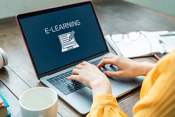 A person using an e-learning platform on a laptop.