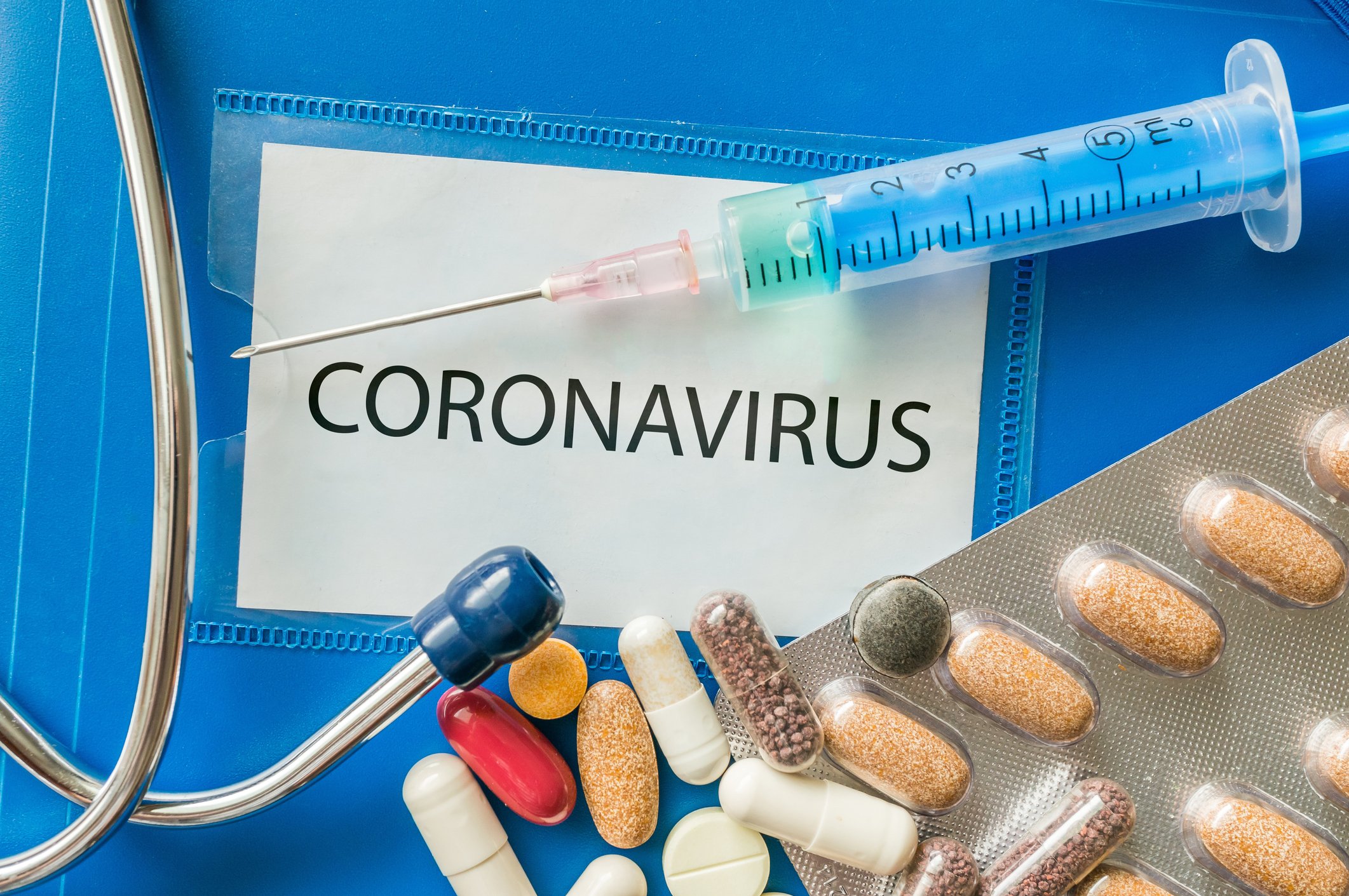 coronavirus name tag and syringe with pills