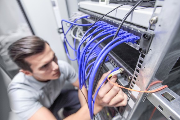 Man working in network server room.