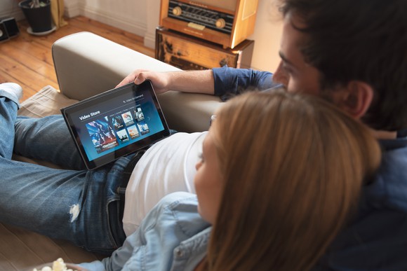 A couple streaming movies on a tablet.